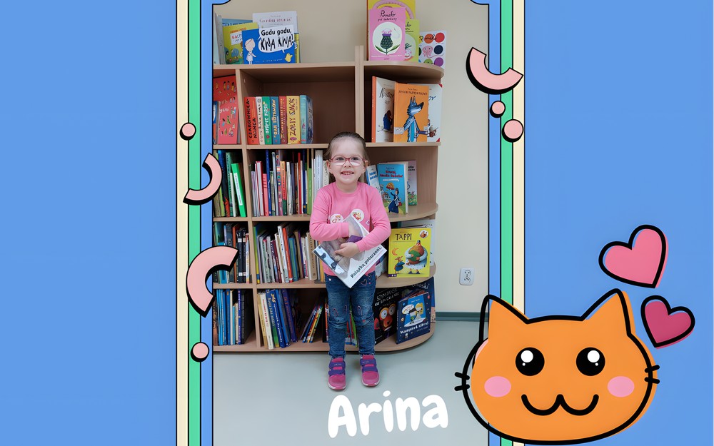 Dziewczynka pozuje z książką z projektu ,,Mała ksiażka, wielki człowiek"