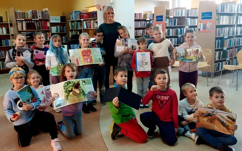 Dzieci z klasy IF wraz z wychowawczynią pozują do wspólnego zdjęcia w bibliotece