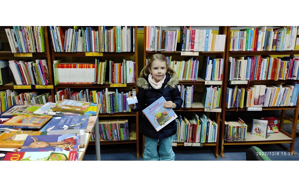 dziewczynka pozuje z pakietem mała książka, wielk człowiek