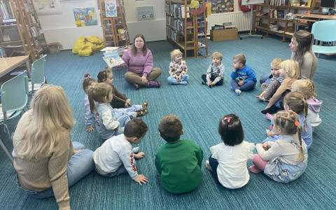 bibliotekarka czyta dzieciom opowiadanie o małym pingwinie