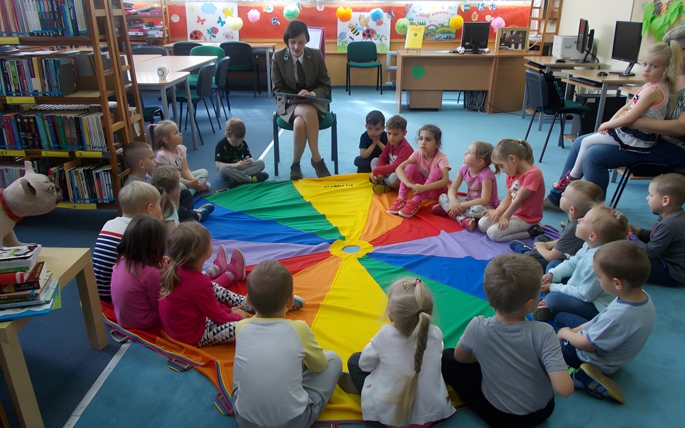 Leśniczyna czyta dzieciom książkę