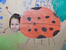 Dziewczynka pozuje do zdjęcia z makietą