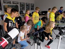 Filia nr 9. Dzieci na wycieczce w Obserwatorium Astronomicznym. Dwie dzziewczynki i chłopiec korzyst