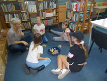 Dzieci siedzą na dywanie podczas wspólnej zabawy