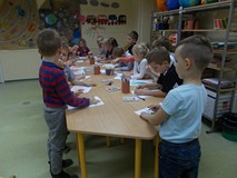 Dzieci przy rysują jesienne warzywa i owoce