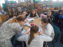 Dziewczynki siedzą przy stole i pracują w grupach