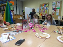 Dzieci siedzą przy stole podczas rozmowy o przeczytanej książce