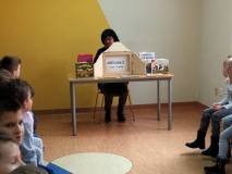 Bibliotekarka czyta grupie dzieci.