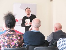 Piotr Słomski trzyma w rękach swoją książkę 