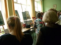 na zdjęciu zebrani goście oglądają obrazy