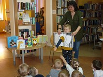 Bibliotekarka prezentuje dzieciom Książkę z dziurą