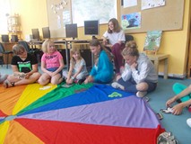 Dzieci siedzą na chuście i naśladują zwierzęta