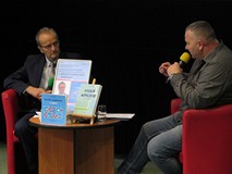 Od lewej: Eugeniusz Żuber, Piotr Pawlikowski. Międzynimi stolik z plakatemi książkami.