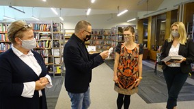 Na zdjęciu od lewej: Małgorzata Zychowicz bibliotekarka,dyrektor KBP Dariusz Pawlikowski wręcza meda
