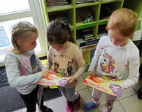 Dzieci oglądają otrzymane w prezencie książki
