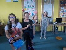 trzy dziewczynki pozują do zdjęcia z medalami