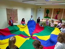 Dzieci podczas wspólnej zabawy z chustą animacyjną