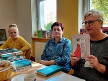 Na zdjęciu Ewa prezentuje tomik poezji pt. CZERWONA SUKNIA swojego autorstwa