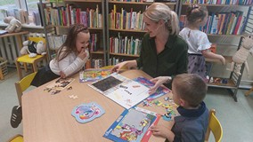 Bibliotekarka pokazuje dzieciom książkę