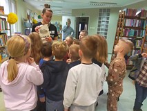 Bibliotekarka pokazuje dzieciom ilustrację