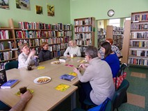 na zdjęciu zebrali siedzą przy stole i dyskutują