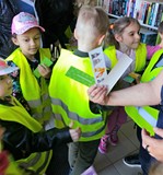 Dzieci otrzymują zakładki do książek