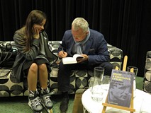 Czytelniczka i Piotr Tyma podczas podpisywania książki.