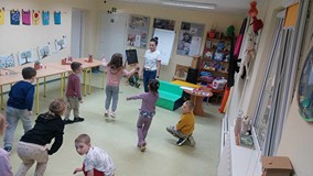 Przedszkolaki i bibliotekarka bawią się w pokazywanie oznak wiosny