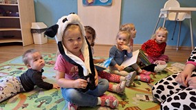 dziewczynka pozuje do zdjęcia z czapką pandy do głowy
