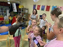 Dziei oglądają sowę podczas zajęć przyrodniczych