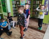 Chłopcy idą z książką na głowie
