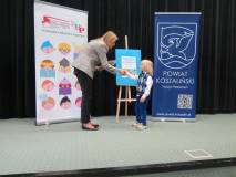 Wicedyrektor KBP Beata Sawa-Jovanoska wręcza upominek uczestnikowi Powiatowego przeglądu recytatorsk