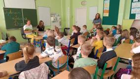 Bibliotekarki czytają zasłuchanym dzieciom bajkę