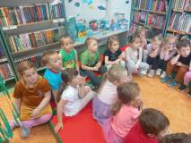 Dzieci słuchają opowiadania o wyprawie na tajemniczą wyspę.