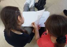 Na zdjęciu dzieci przeglądają przygotowane dla nich książki