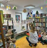 Bibliotekarka z dziećmi ustawiają bałwanki z wiersza Wandy Chotomskiej pt. 