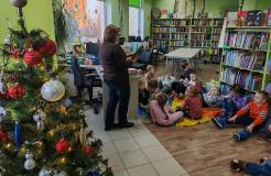 Pani Ania czyta dzieciom siedzącym na podłodze