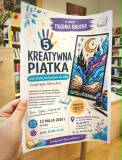 Zdjęcie przedstawia plakat trzymany w dłoni, na tle wnętrza biblioteki