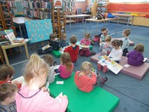 Dzieci oglądają książki na materacach