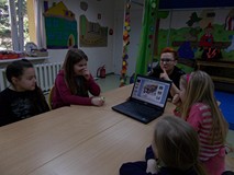 Grupa feriowiczów i strażniczka miejska, która przypomina jak zachować sie bezpiecznie np. na lodowi