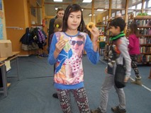 Dziewczynka stoi i je pączka