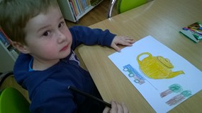 Chłopiec koloruje czajniczek