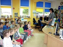 Bibliotekarka opowiada dzieciom historię koszalińskiego herbu