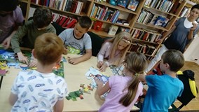 Filia nr 4. Grupa dzieci układa puzzle.